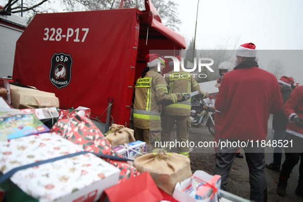 In Krakow, Poland, on December 8, 2024, motorcyclists in Santa costumes hand out gifts at the University Children's Hospital. Santas on moto...