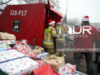 In Krakow, Poland, on December 8, 2024, motorcyclists in Santa costumes hand out gifts at the University Children's Hospital. Santas on moto...