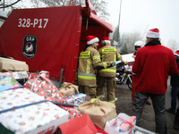 In Krakow, Poland, on December 8, 2024, motorcyclists in Santa costumes hand out gifts at the University Children's Hospital. Santas on moto...