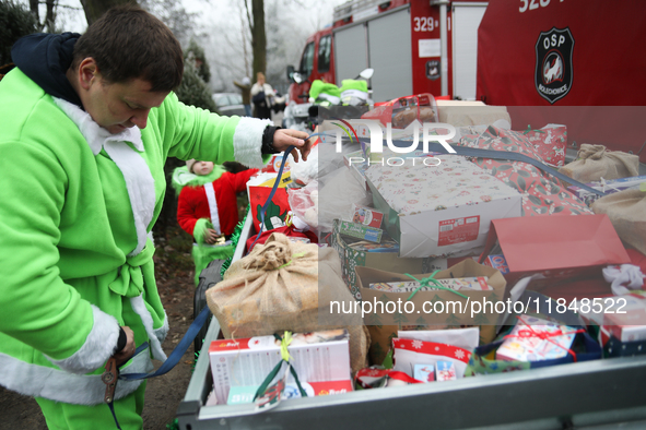 In Krakow, Poland, on December 8, 2024, motorcyclists in Santa costumes hand out gifts at the University Children's Hospital. Santas on moto...