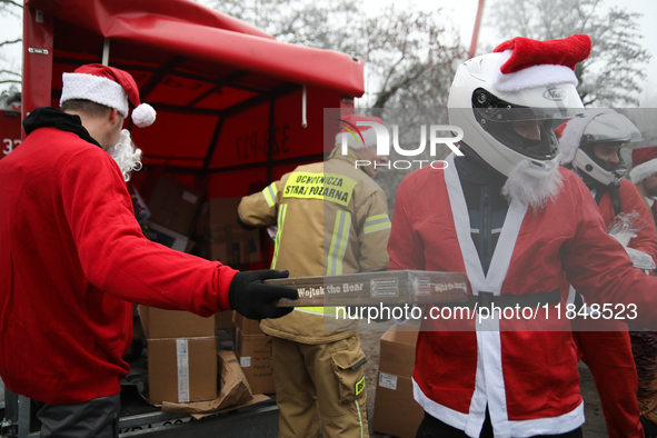 In Krakow, Poland, on December 8, 2024, motorcyclists in Santa costumes hand out gifts at the University Children's Hospital. Santas on moto...