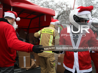 In Krakow, Poland, on December 8, 2024, motorcyclists in Santa costumes hand out gifts at the University Children's Hospital. Santas on moto...