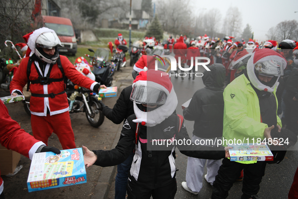 In Krakow, Poland, on December 8, 2024, motorcyclists in Santa costumes hand out gifts at the University Children's Hospital. Santas on moto...