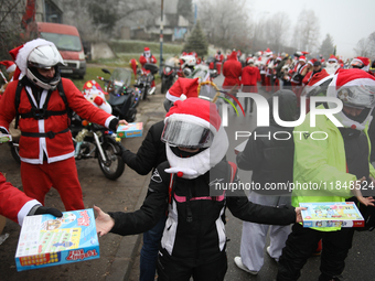 In Krakow, Poland, on December 8, 2024, motorcyclists in Santa costumes hand out gifts at the University Children's Hospital. Santas on moto...