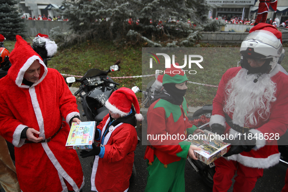 In Krakow, Poland, on December 8, 2024, motorcyclists in Santa costumes hand out gifts at the University Children's Hospital. Santas on moto...