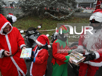 In Krakow, Poland, on December 8, 2024, motorcyclists in Santa costumes hand out gifts at the University Children's Hospital. Santas on moto...