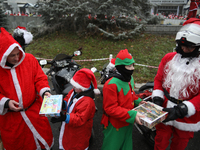 In Krakow, Poland, on December 8, 2024, motorcyclists in Santa costumes hand out gifts at the University Children's Hospital. Santas on moto...