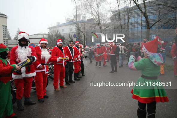 In Krakow, Poland, on December 8, 2024, motorcyclists in Santa costumes hand out gifts at the University Children's Hospital. Santas on moto...