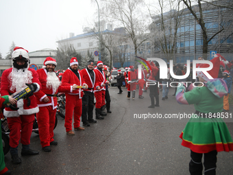 In Krakow, Poland, on December 8, 2024, motorcyclists in Santa costumes hand out gifts at the University Children's Hospital. Santas on moto...