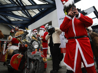 In Krakow, Poland, on December 8, 2024, motorcyclists in Santa costumes hand out gifts at the University Children's Hospital. Santas on moto...