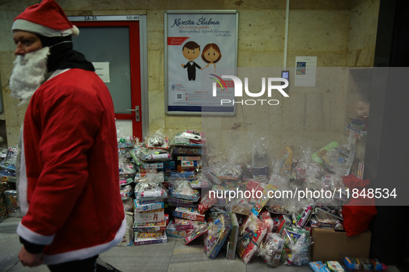 In Krakow, Poland, on December 8, 2024, motorcyclists in Santa costumes hand out gifts at the University Children's Hospital. Santas on moto...