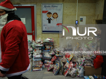 In Krakow, Poland, on December 8, 2024, motorcyclists in Santa costumes hand out gifts at the University Children's Hospital. Santas on moto...