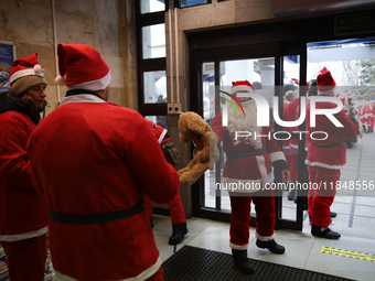 In Krakow, Poland, on December 8, 2024, motorcyclists in Santa costumes hand out gifts at the University Children's Hospital. Santas on moto...