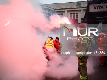 Motorcyclists in Santa costumes burn a tire on their motorcycle while handing out gifts at the University Children's Hospital in Krakow, Pol...