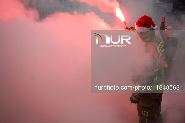 Motorcyclists in Santa costumes burn a tire on their motorcycle while handing out gifts at the University Children's Hospital in Krakow, Pol...