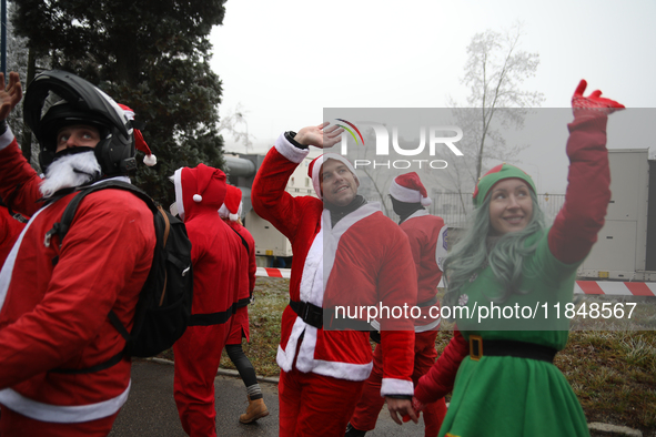 Motorcyclists in Santa costumes greet sick children while handing out gifts at the University Children's Hospital in Krakow, Poland, on Dece...