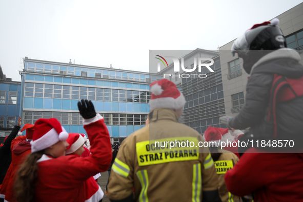 Motorcyclists in Santa costumes greet sick children while handing out gifts at the University Children's Hospital in Krakow, Poland, on Dece...