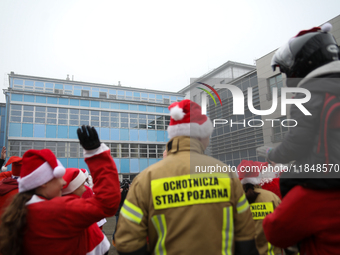 Motorcyclists in Santa costumes greet sick children while handing out gifts at the University Children's Hospital in Krakow, Poland, on Dece...