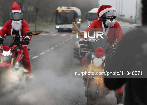 In Krakow, Poland, on December 8, 2024, motorcyclists in Santa costumes ride through the streets of the city to the University Children's Ho...