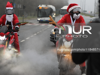 In Krakow, Poland, on December 8, 2024, motorcyclists in Santa costumes ride through the streets of the city to the University Children's Ho...