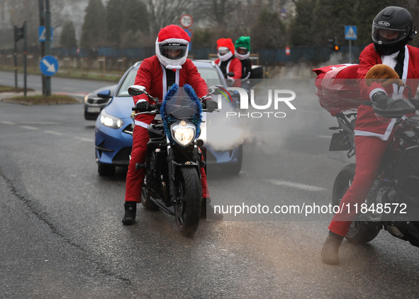 In Krakow, Poland, on December 8, 2024, motorcyclists in Santa costumes ride through the streets of the city to the University Children's Ho...