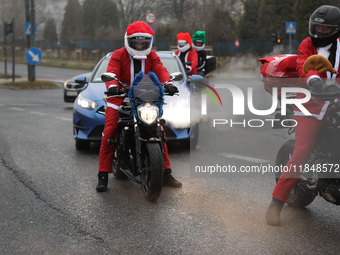 In Krakow, Poland, on December 8, 2024, motorcyclists in Santa costumes ride through the streets of the city to the University Children's Ho...