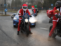 In Krakow, Poland, on December 8, 2024, motorcyclists in Santa costumes ride through the streets of the city to the University Children's Ho...