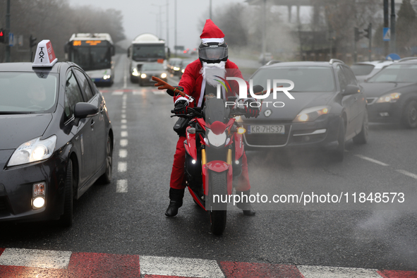 In Krakow, Poland, on December 8, 2024, motorcyclists in Santa costumes ride through the streets of the city to the University Children's Ho...