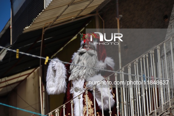 Miguel Moctezuma is characterized as Santa Claus Illuminated during his visit to some of the iconic places in the Tepito neighborhood as par...