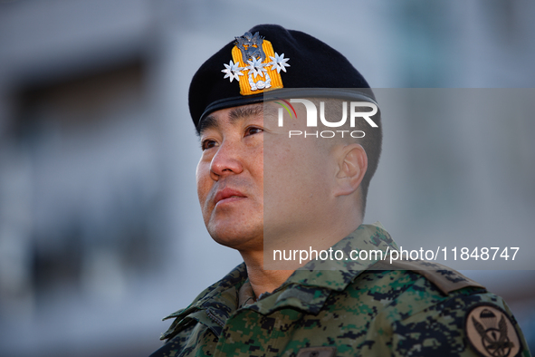 Colonel Kim Hyun-tae, Commander of the 707th Special Mission Group, sheds tears during a press conference in front of the Defense Convention...