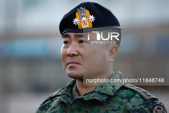 Colonel Kim Hyun-tae, Commander of the 707th Special Mission Group, sheds tears during a press conference in front of the Defense Convention...