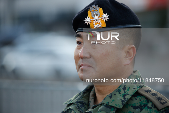 Colonel Kim Hyun-tae, Commander of the 707th Special Mission Group, sheds tears during a press conference in front of the Defense Convention...