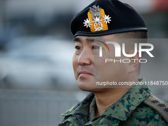 Colonel Kim Hyun-tae, Commander of the 707th Special Mission Group, sheds tears during a press conference in front of the Defense Convention...