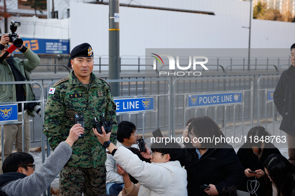 Colonel Kim Hyun-tae, Commander of the 707th Special Mission Group, holds a press conference in front of the Defense Convention Center in Yo...