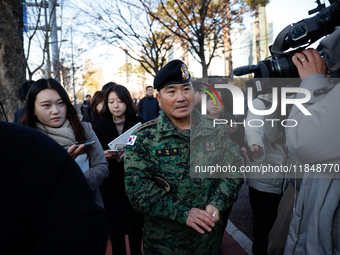 Colonel Kim Hyun-tae, Commander of the 707th Special Mission Group, holds a press conference in front of the Defense Convention Center in Yo...