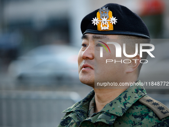 Colonel Kim Hyun-tae, Commander of the 707th Special Mission Group, holds a press conference in front of the Defense Convention Center in Yo...