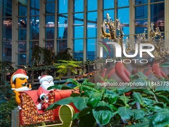 Visitors watch Santa Claus' flying sleigh ride at Halo Shopping Park in Chongqing, China, on December 8, 2024. (