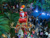 Visitors look at a Santa Claus installation at the Halo Shopping Park in Chongqing, China, on December 8, 2024. (