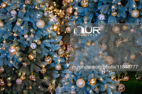 Visitors look at a Christmas tree installation at the Halo Shopping Park in Chongqing, China, on December 8, 2024. 