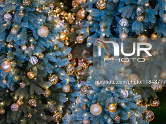 Visitors look at a Christmas tree installation at the Halo Shopping Park in Chongqing, China, on December 8, 2024. (