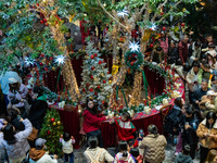 Visitors look at a Christmas tree installation at the Halo Shopping Park in Chongqing, China, on December 8, 2024. (