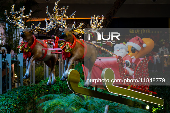 Visitors watch Santa Claus' flying sleigh ride at Halo Shopping Park in Chongqing, China, on December 8, 2024. 