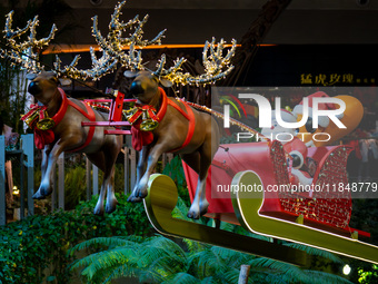 Visitors watch Santa Claus' flying sleigh ride at Halo Shopping Park in Chongqing, China, on December 8, 2024. (