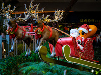 Visitors watch Santa Claus' flying sleigh ride at Halo Shopping Park in Chongqing, China, on December 8, 2024. (