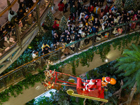 Visitors watch Santa Claus' flying sleigh ride at Halo Shopping Park in Chongqing, China, on December 8, 2024. (