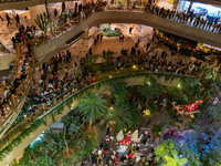 Visitors watch Santa Claus' flying sleigh ride at Halo Shopping Park in Chongqing, China, on December 8, 2024. (