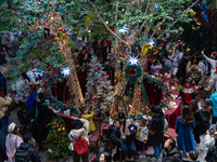 Visitors look at a Christmas tree installation at the Halo Shopping Park in Chongqing, China, on December 8, 2024. (