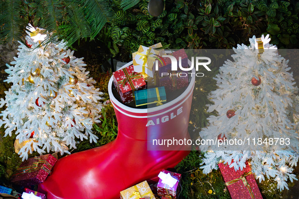 Visitors look at a Christmas tree installation at the Halo Shopping Park in Chongqing, China, on December 8, 2024. 