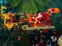 Visitors watch Santa Claus' flying sleigh ride at Halo Shopping Park in Chongqing, China, on December 8, 2024. (