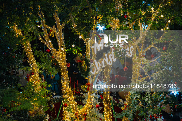 Visitors look at a Christmas tree installation at the Halo Shopping Park in Chongqing, China, on December 8, 2024. 